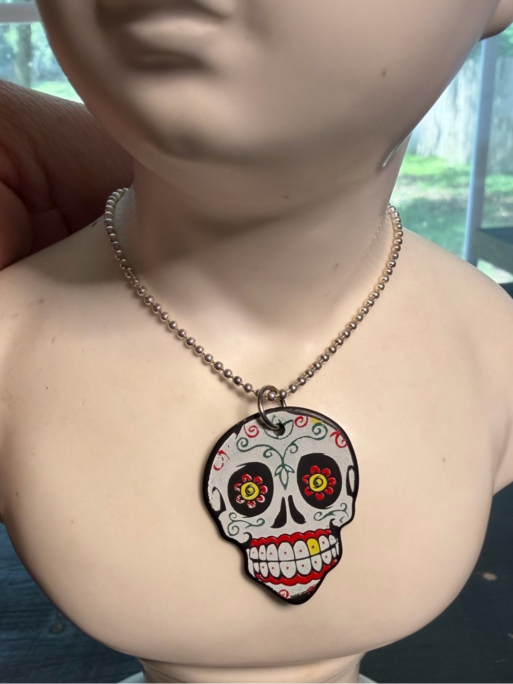 Sugar skull guitar pick necklace.